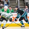Dallas Stars forward Jason Robertson skating by San Jose Sharks defenseman Henry Thrun