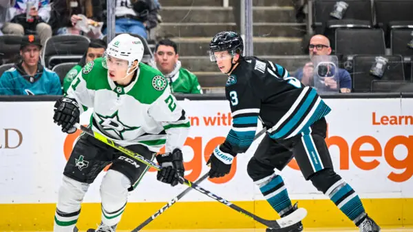 Dallas Stars forward Jason Robertson skating by San Jose Sharks defenseman Henry Thrun