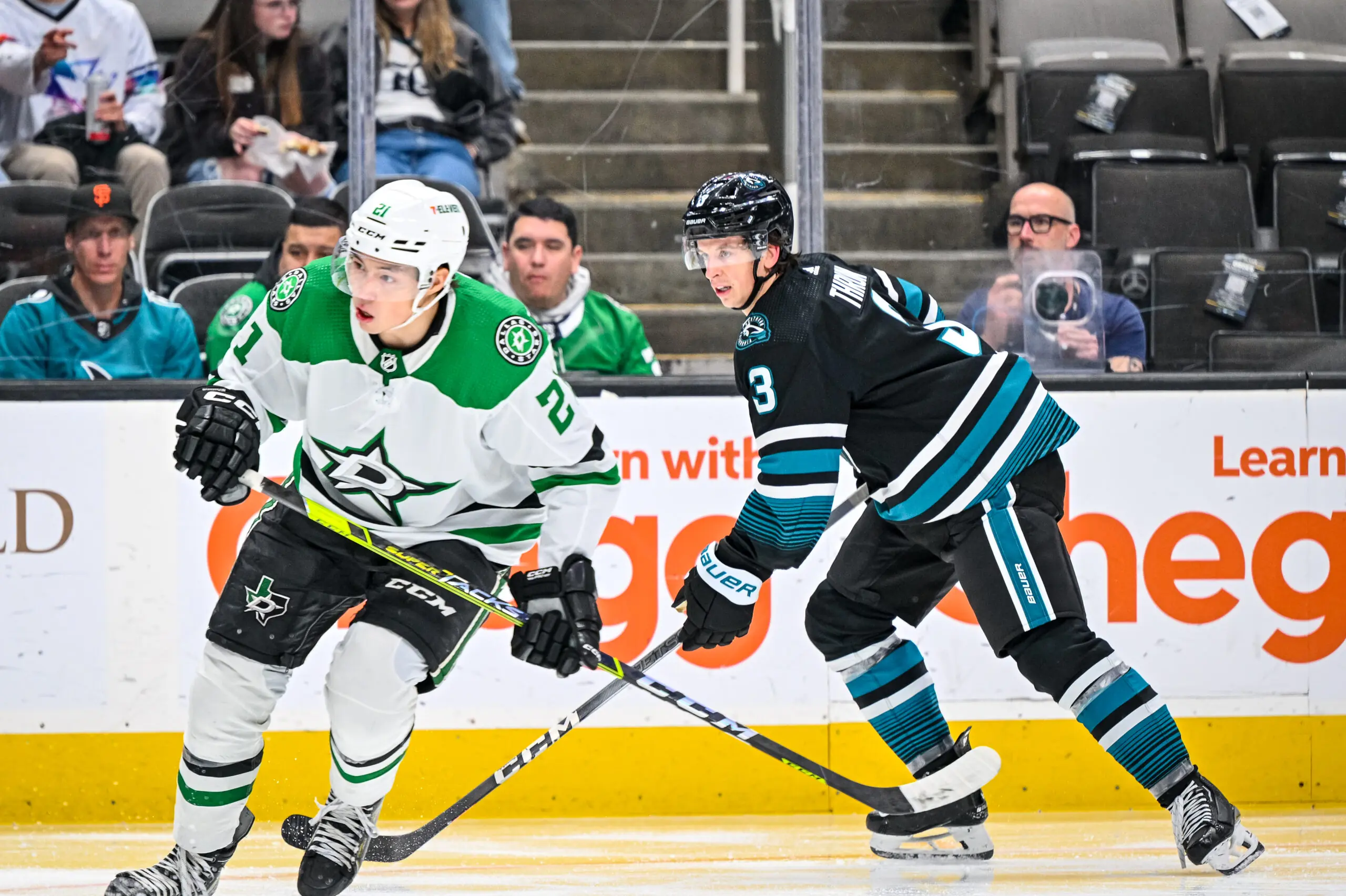 Dallas Stars forward Jason Robertson skating by San Jose Sharks defenseman Henry Thrun