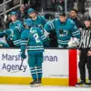 San Jose Sharks forward Will Smith skates by the bench after scoring.