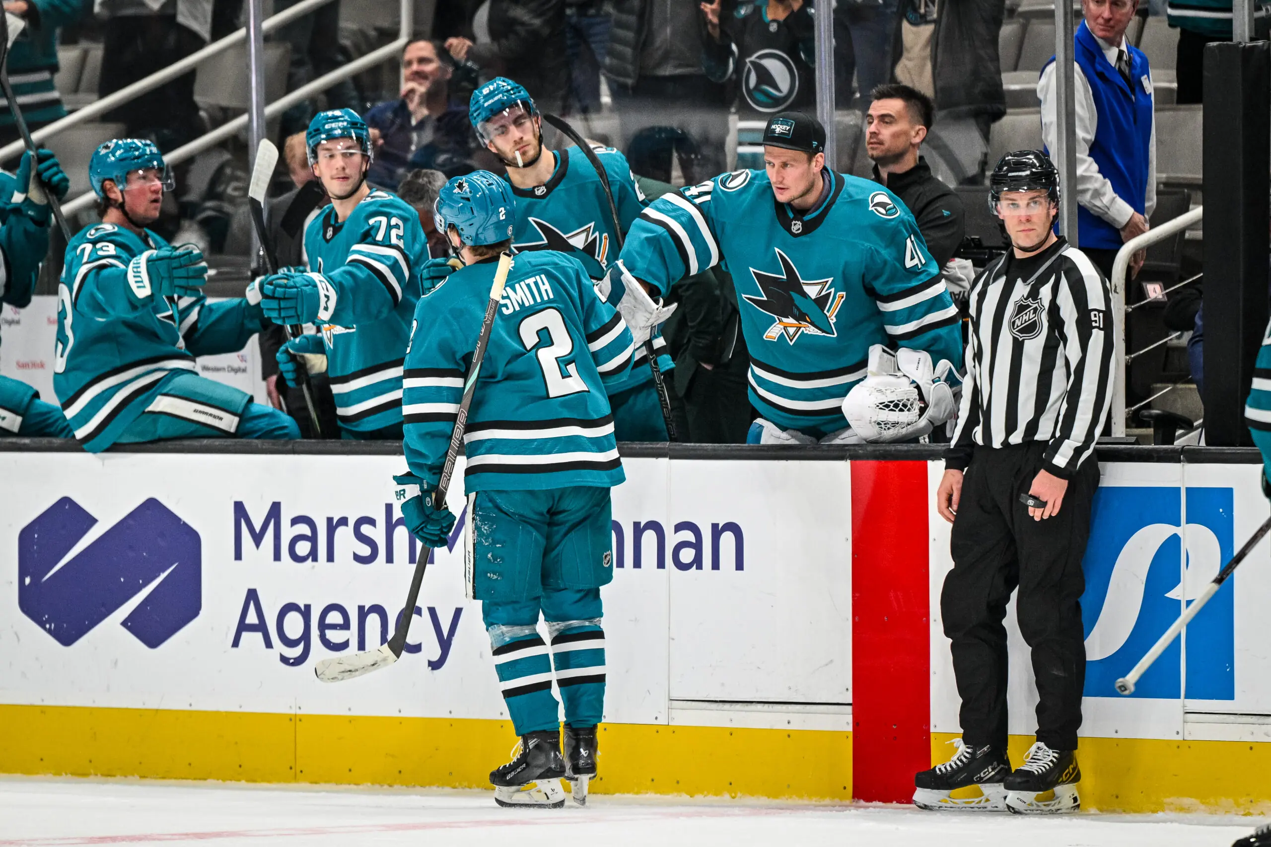 San Jose Sharks forward Will Smith skates by the bench after scoring.